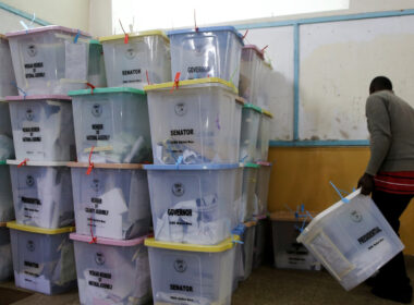 Credit - An election official from the Independent Electoral and Boundaries Commission arranges ballot boxes inside the Jamuhuri High School tallying center in Nairobi, Kenya, on August 9. (Thomas Mukoya / Reuters )